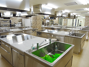 壁面もおしゃれにプロ仕様の最新厨房機器が並ぶ調理実習室